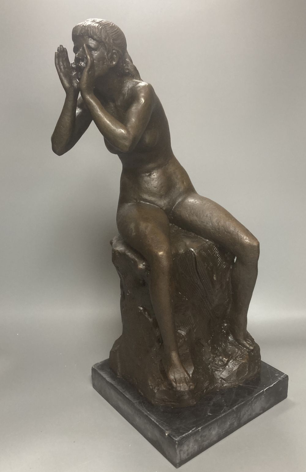 A bronze model of a seated female nude, indistinctly signed Silk, on marble plinth, 52cm